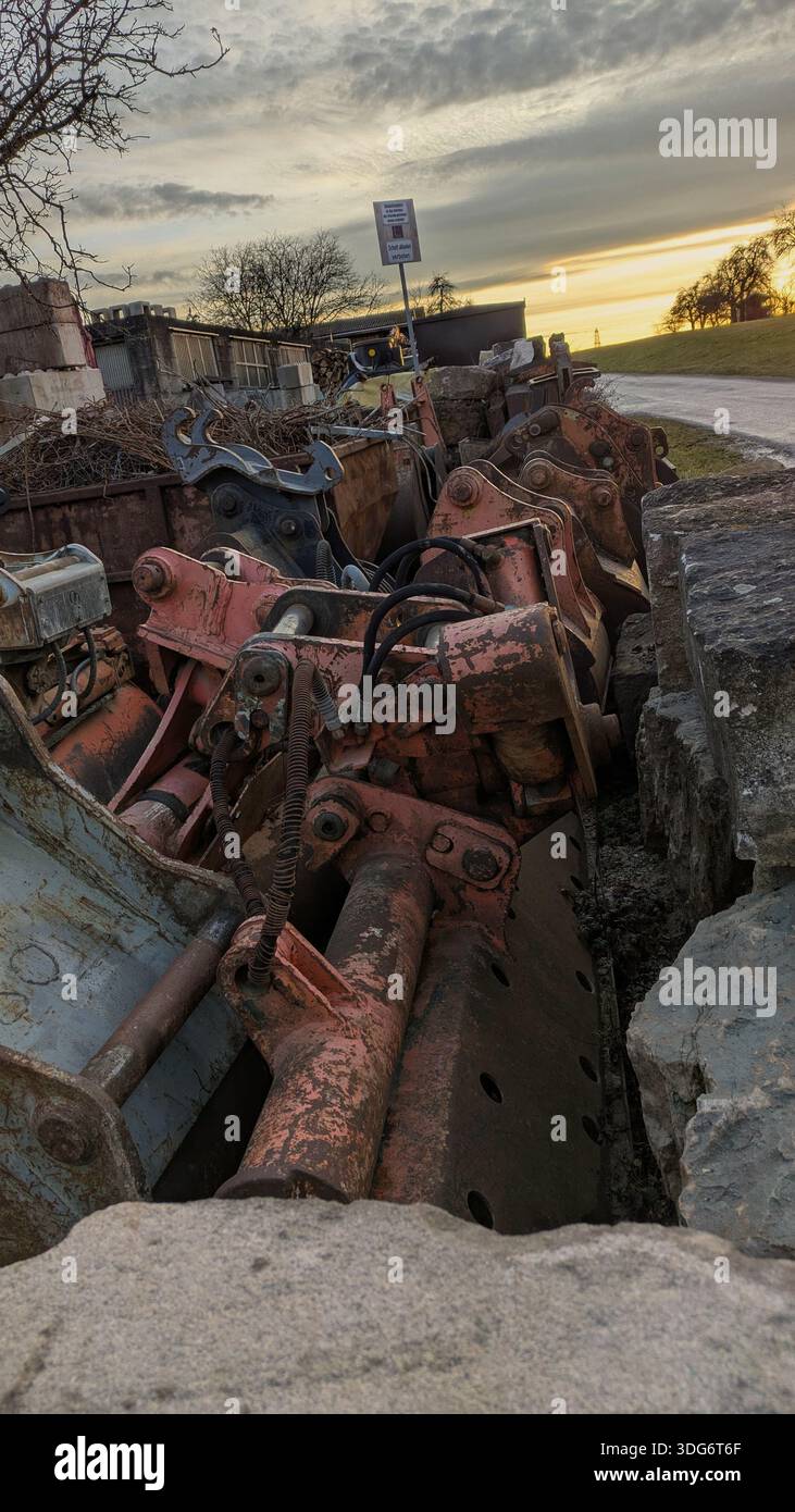 A cluttered scrapyard filled with piles of discarded metal and old machinery parts. - Smartphone Captured Stock Image