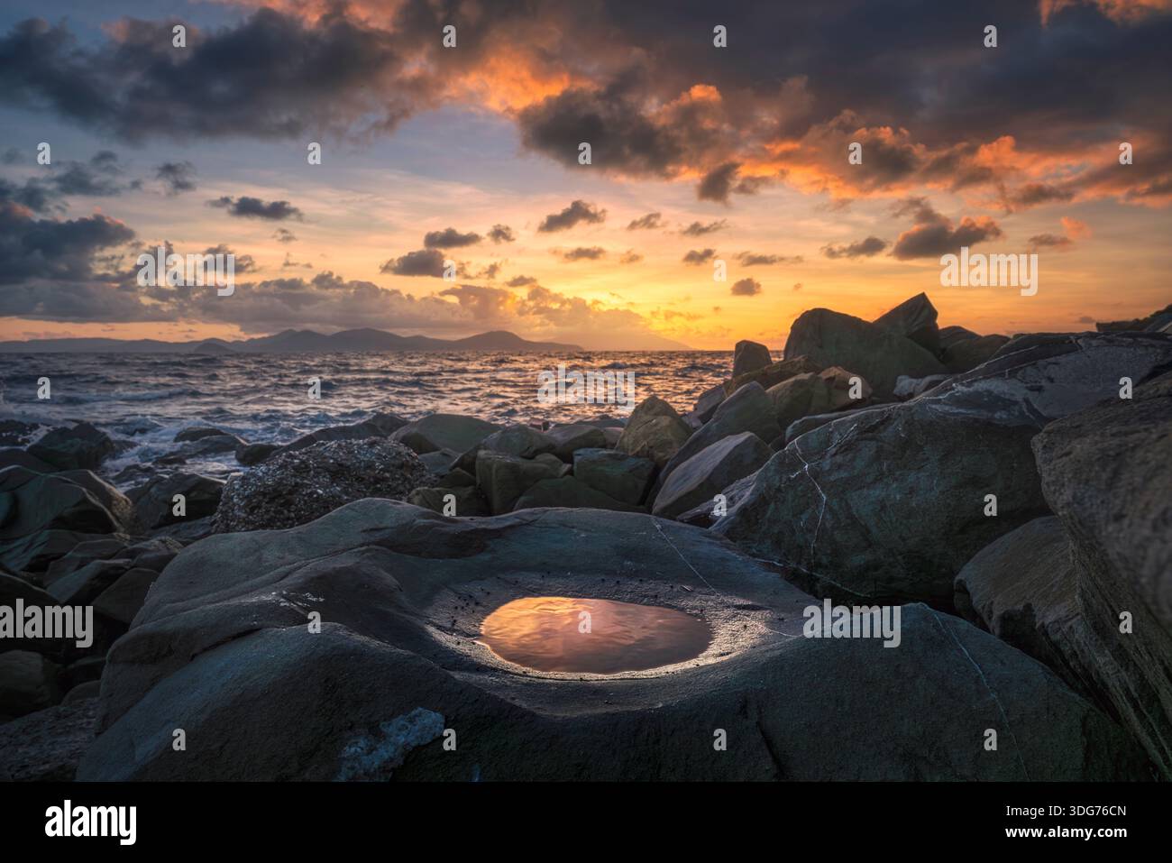 Dramatic sunset on the rocky coast of Piombino, Tuscany, Italy. Small ...