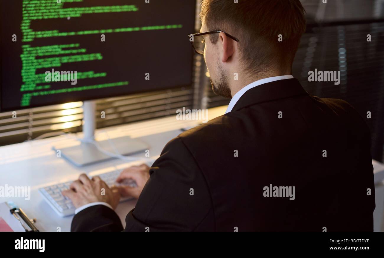 Business programmer man coding at computer in modern office, developer at work Stock Photo