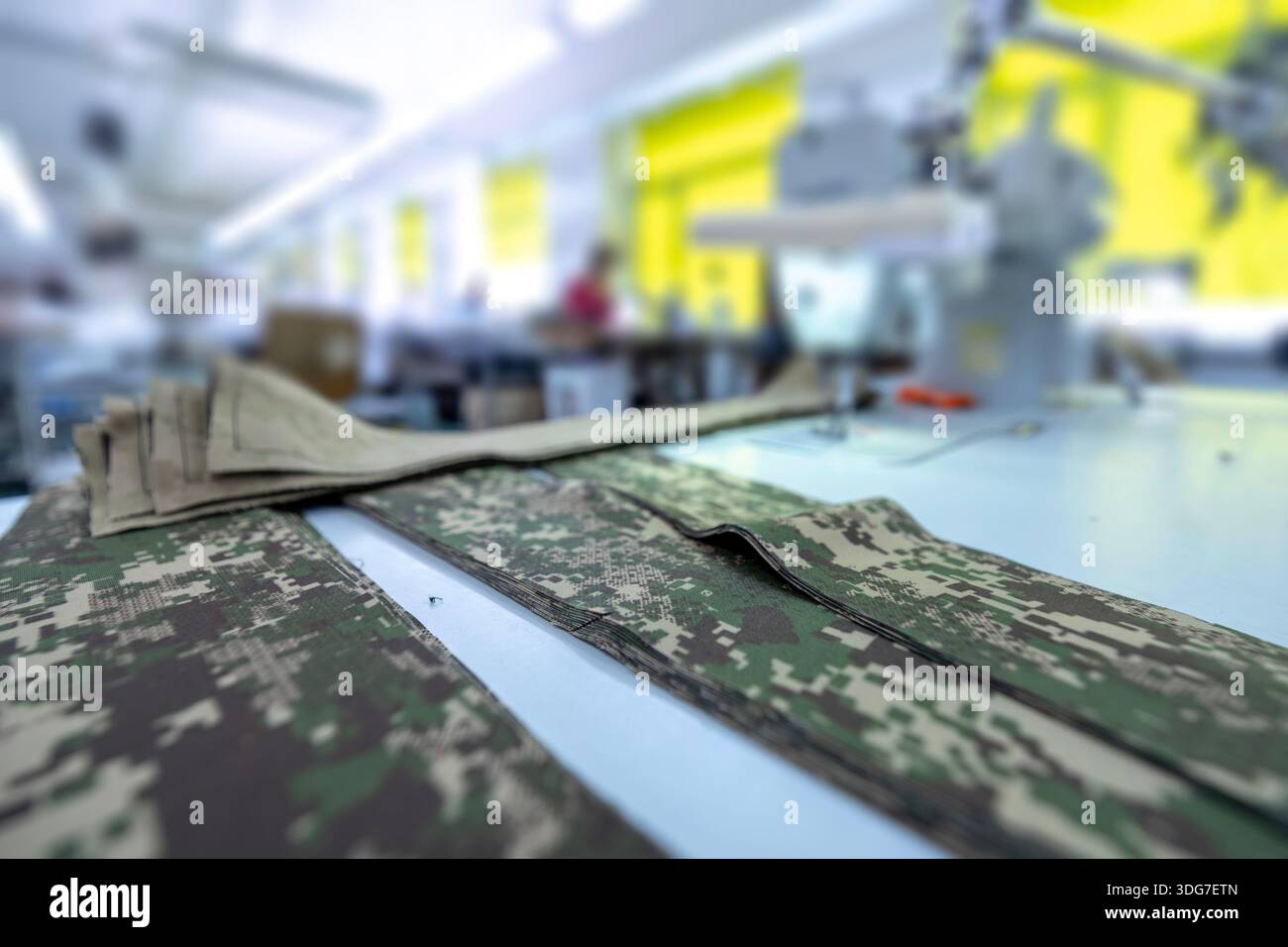 Ready for sewing camouflage fabric parts in garment factory ...