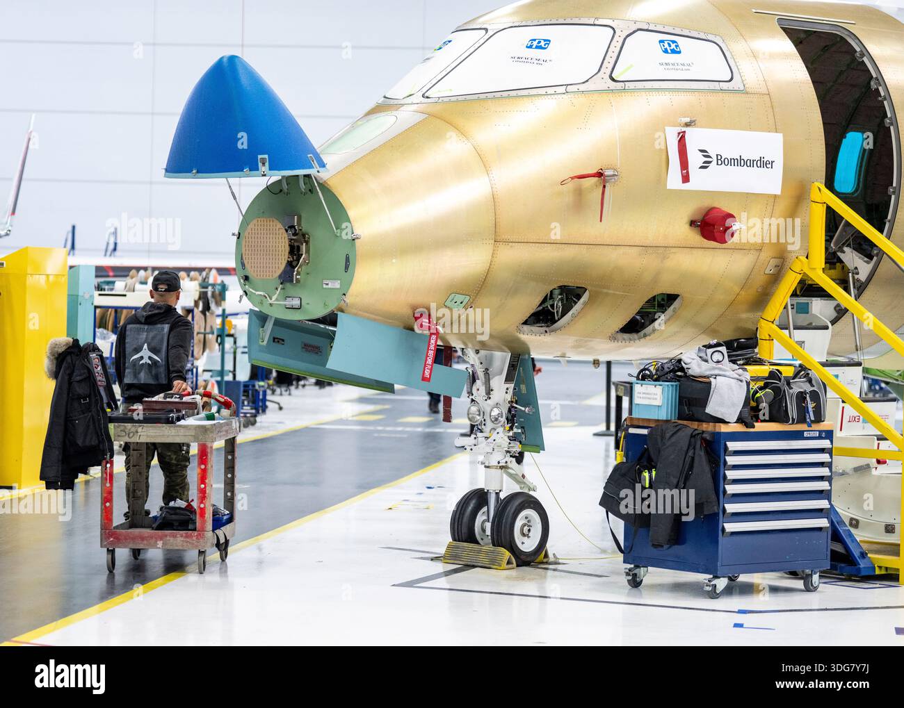 A Bombardier walks past a Challenger jet at their manufacturing ...