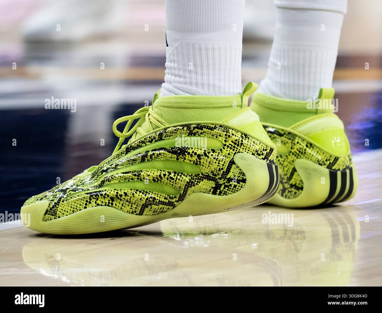 SOUTH BEND, IN - JANUARY 13: A Miami (FL) Hurricanes player wears a pair of  Adidas Harden Vol. 9 "Snakeskin" basketball shoes in a solar lime green and  black colorway during the