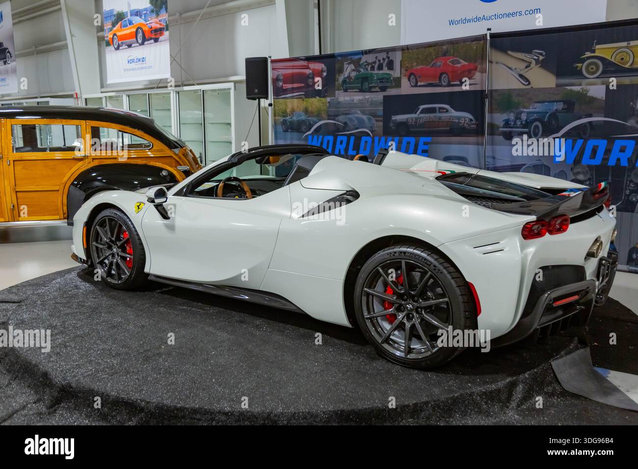 A white Ferrari SF90 Spider convertible hybrid sports car on