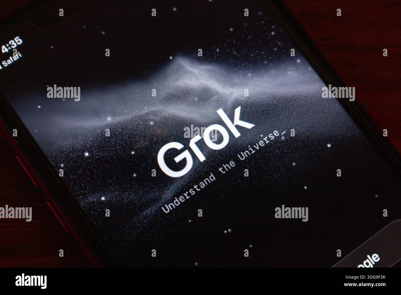 Close-up of a smartphone showing the Grok AI launch screen with cosmic ...