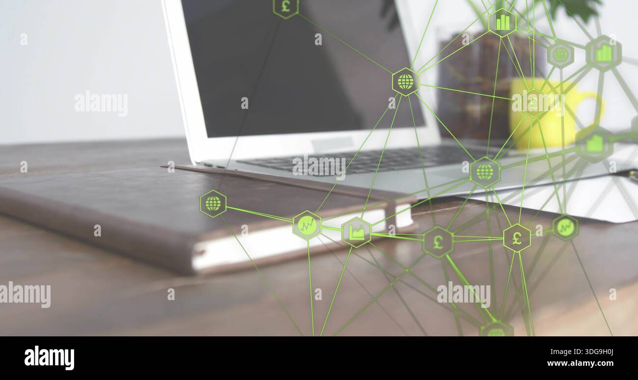 Displaying silver laptop resting on brown leather folio on wood desk, showing green network overlay Stock Photo