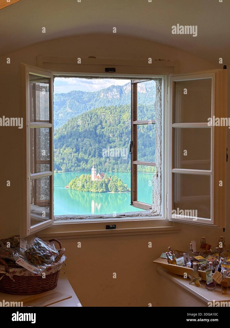 Turquoise waters, forested hills, and alpine peaks complete this iconic Slovenian landscape. - Smartphone Captured Stock Image