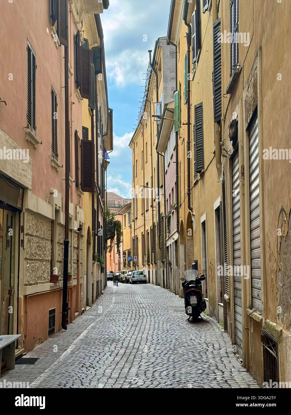 Charming street scene in Mantua, Italy, with porticos, balconies, and outdoor cafés in warm tones - Smartphone Captured Stock Image