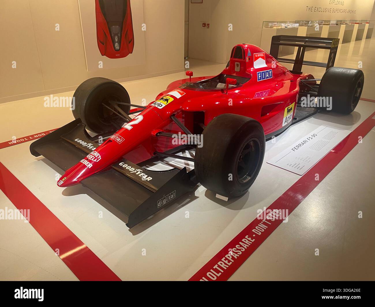 Historic Ferrari Formula 1 racing car on display in an automotive museum, showcasing Italian motorsport heritage and classic engineering - Smartphone Captured Stock Image