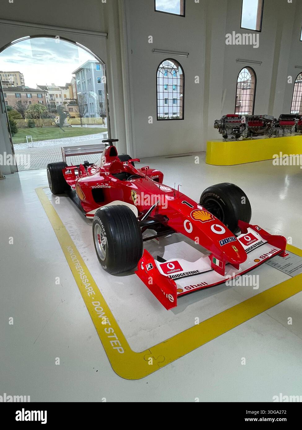 Historic Ferrari Formula 1 racing car on display in an automotive museum, showcasing Italian motorsport heritage and classic engineering - Smartphone Captured Stock Image