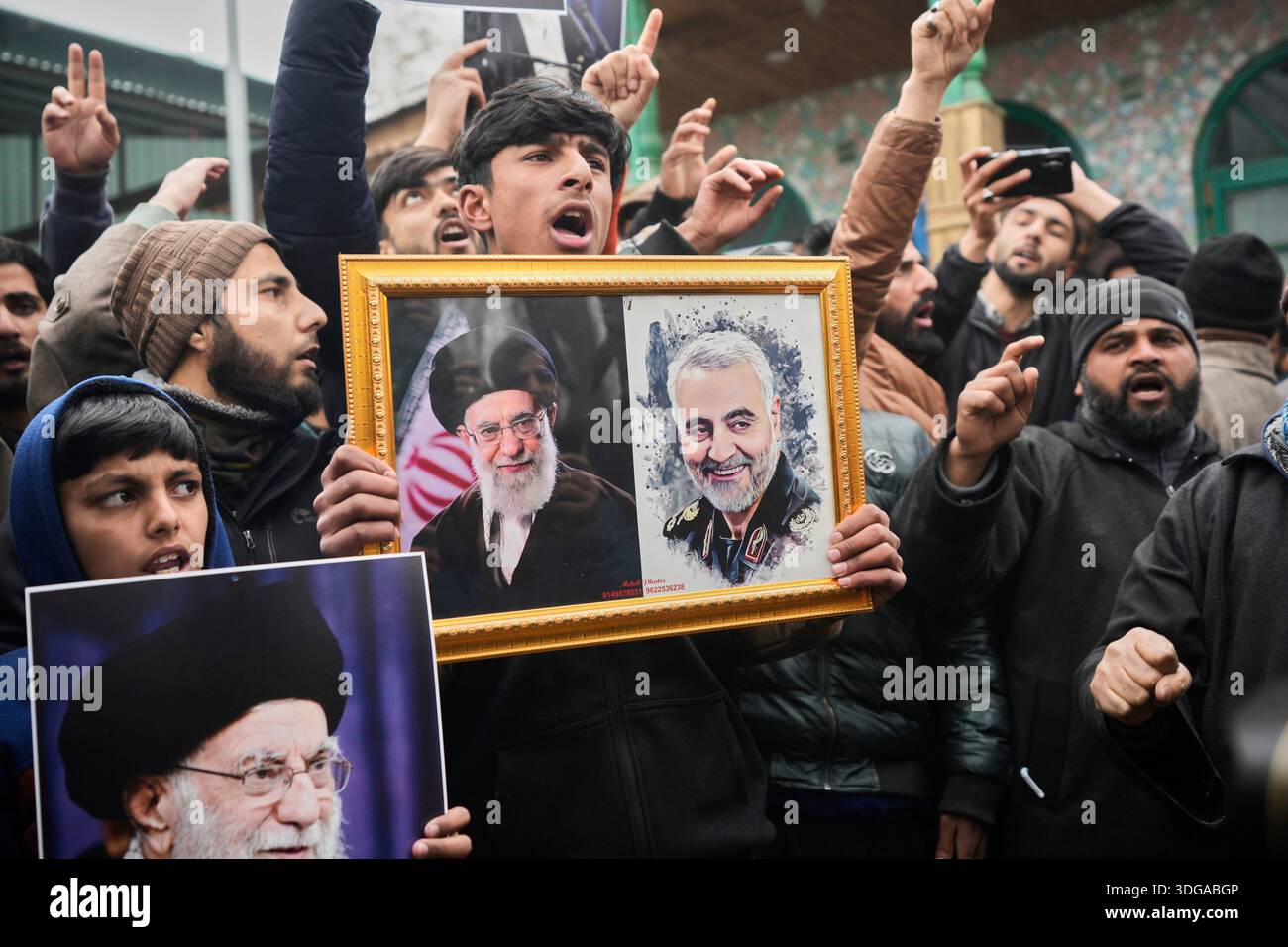 Kashmiri Shiite Muslim protesters chant slogans and hold photographs of ...