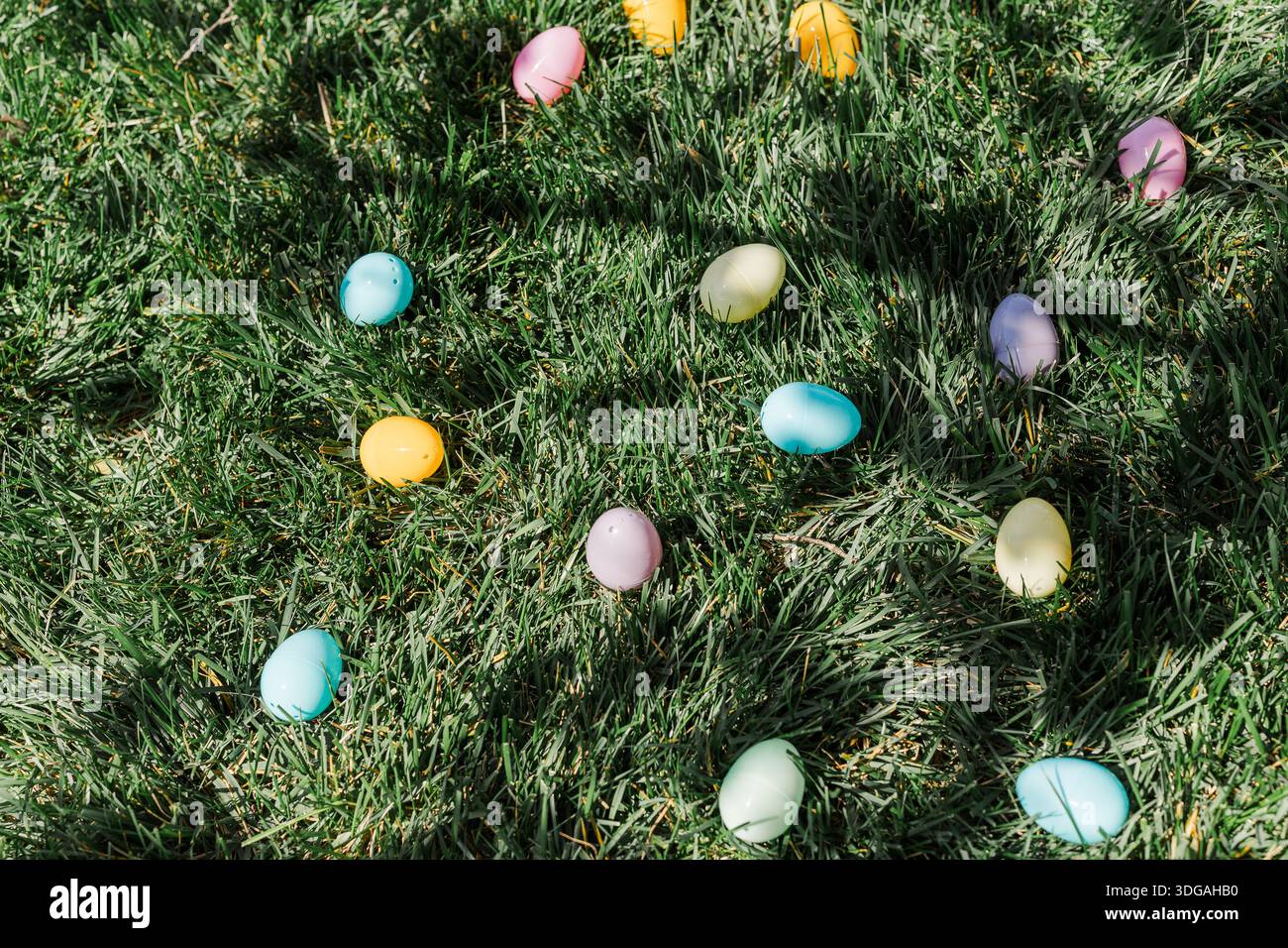 Plastic Easter eggs laying in the green grass. Stock Photo