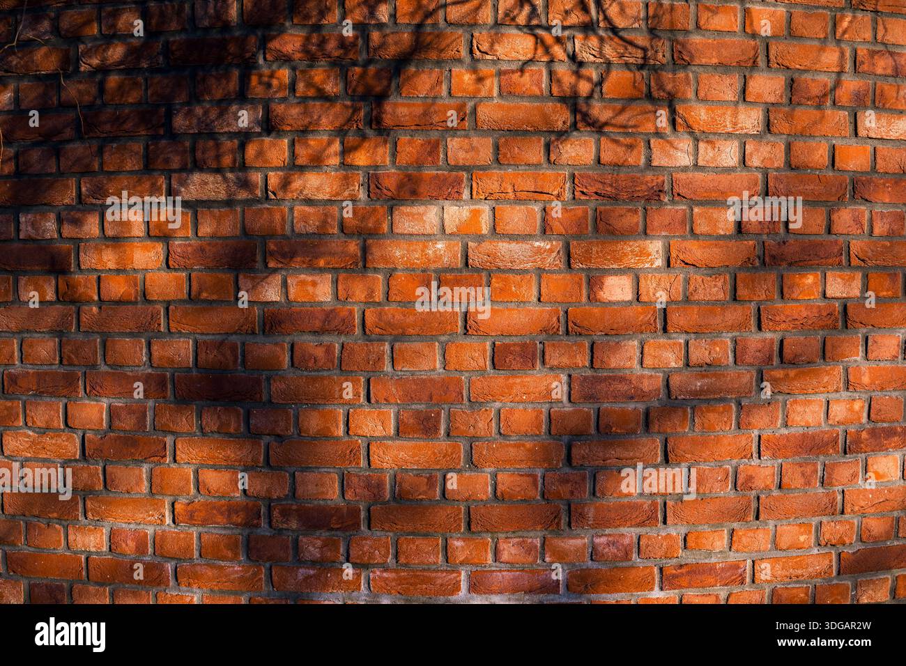 Red Brick Wall Texture with Natural Light and Shadow Patterns Stock Photo