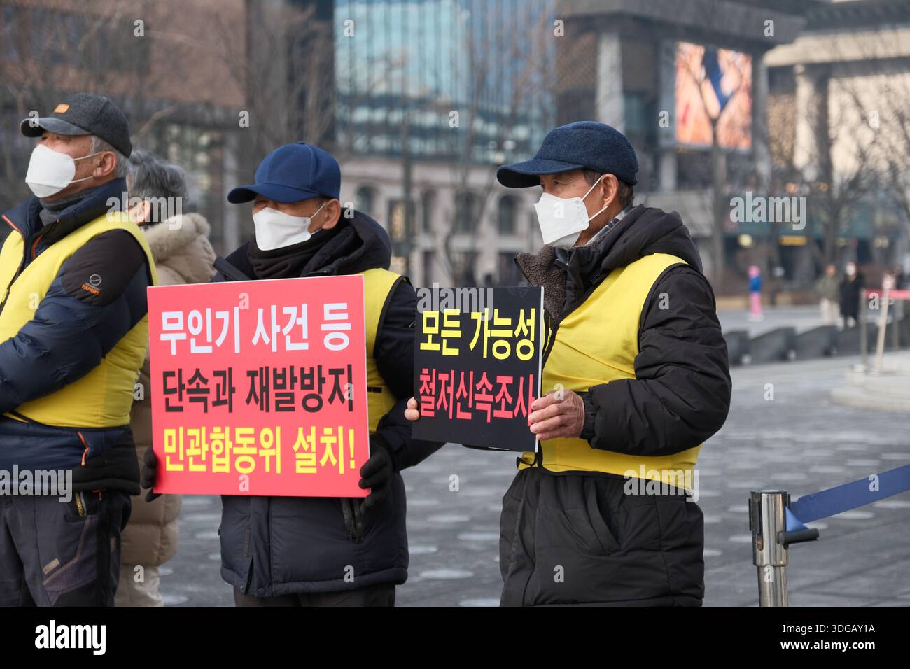 Seoul, South Korea: Protesters wearing masks hold placards demanding investigation and prevention of drone incidents during a rally Stock Photo