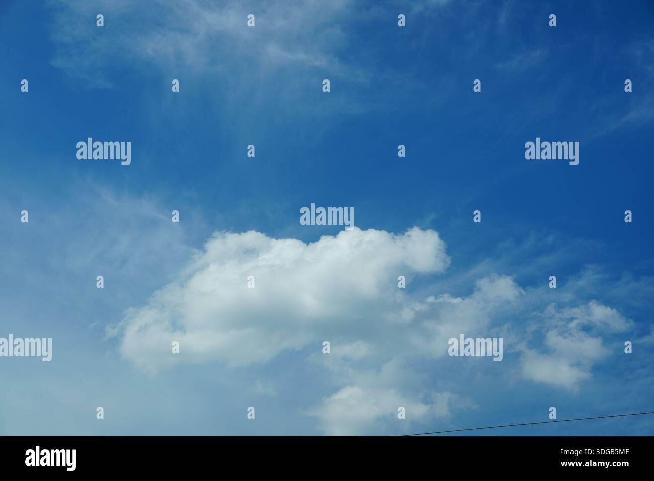 A large white cloud is in the blue sky Stock Photo