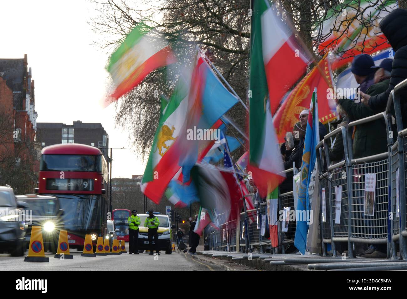 Demonstrators hold placards, banner and flags as they protest outside ...