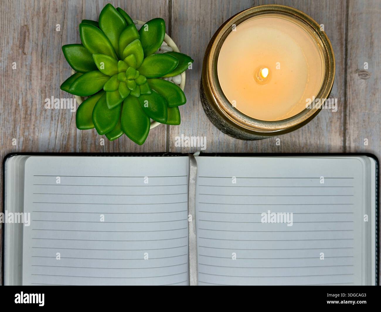 Calming Self Care Scene With Candle, Journal, and Plant on Wooden Surface - Smartphone Captured Stock Image