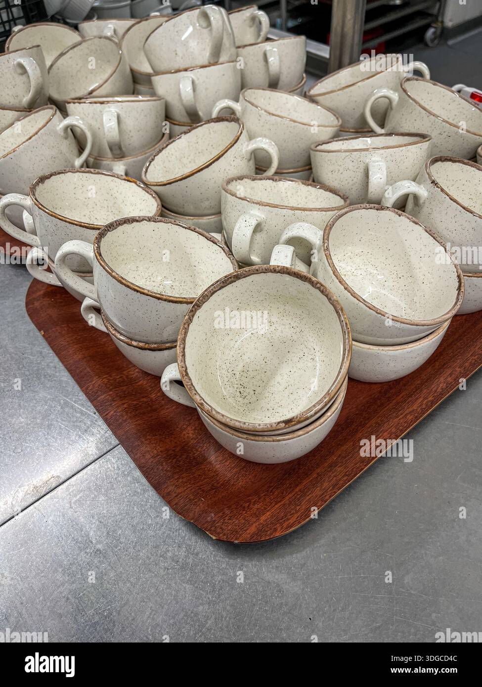 Churchill Stonecast Barley White speckled ceramic cups on a tray in a restaurant kitchen - Smartphone Captured Stock Image