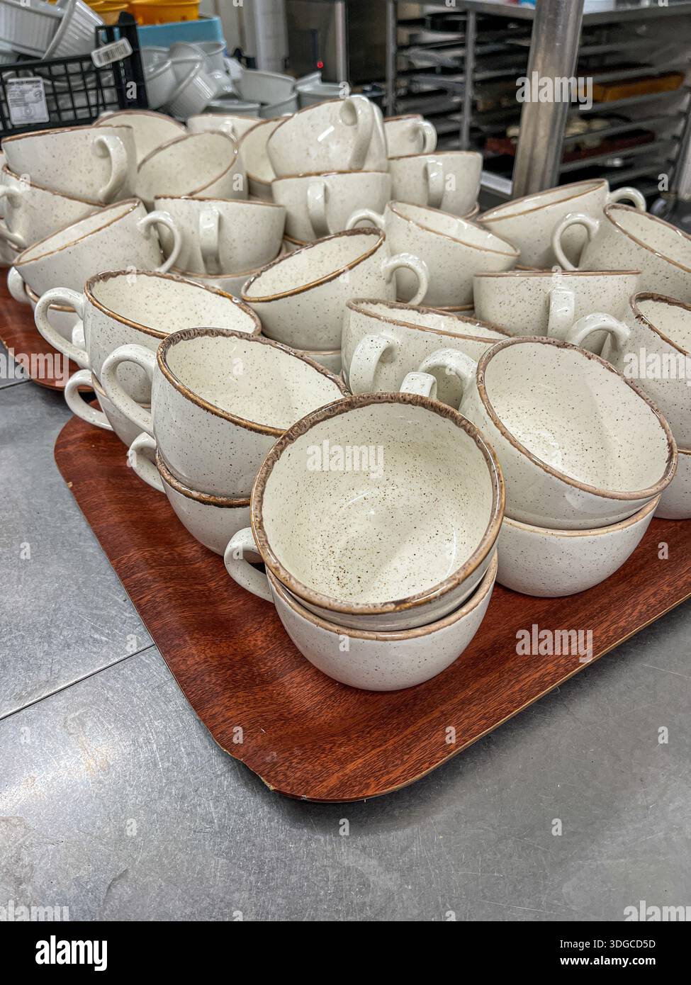 Churchill Stonecast Barley White speckled ceramic cups on a tray in a restaurant kitchen - Smartphone Captured Stock Image