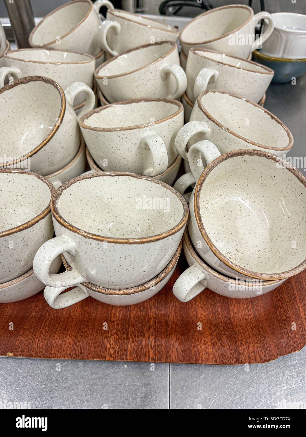 Churchill Stonecast Barley White speckled ceramic cups on a tray in a restaurant kitchen - Smartphone Captured Stock Image