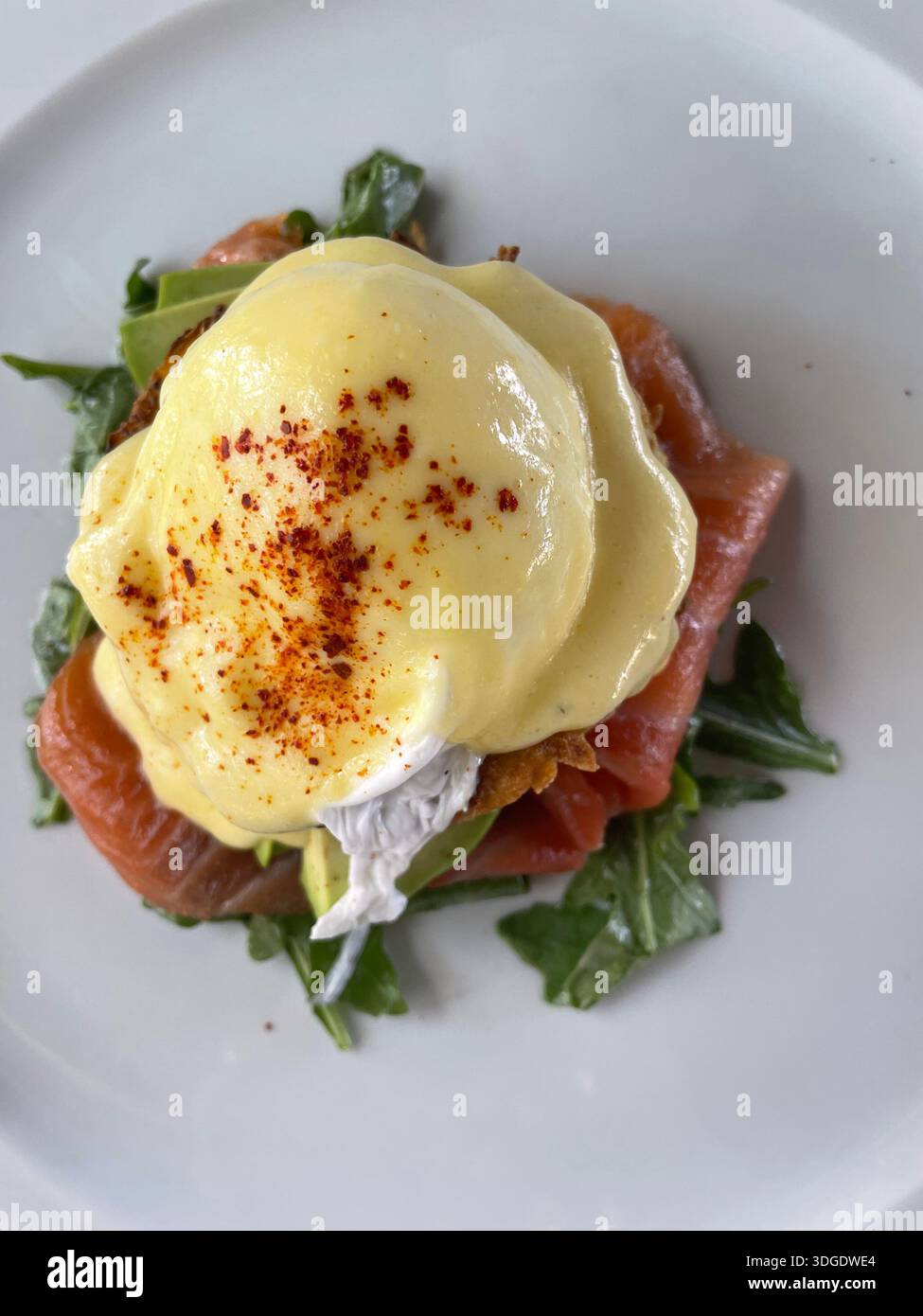 overhead of eggs benedict on white plate Stock Photo