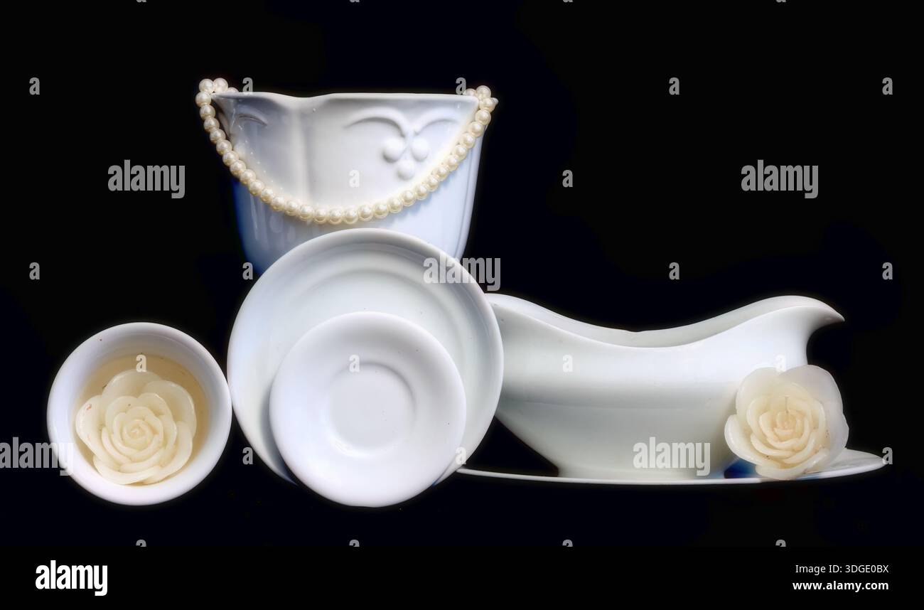 White dishes on black background Stock Photo