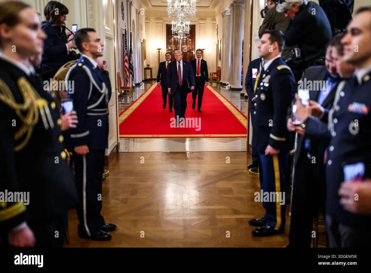 President Donald Trump walks down the Cross Hall of the White House ...