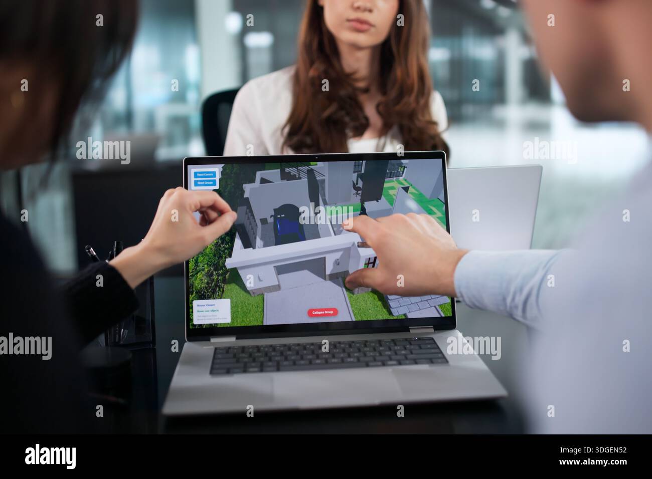 Diverse Team Of Engineers Using CAD Software For Home Construction. Stock Photo