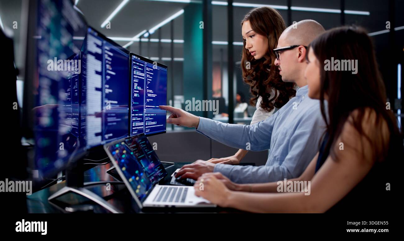 Team Of Engineers Collaborating On Software Development In Busy Office Stock Photo