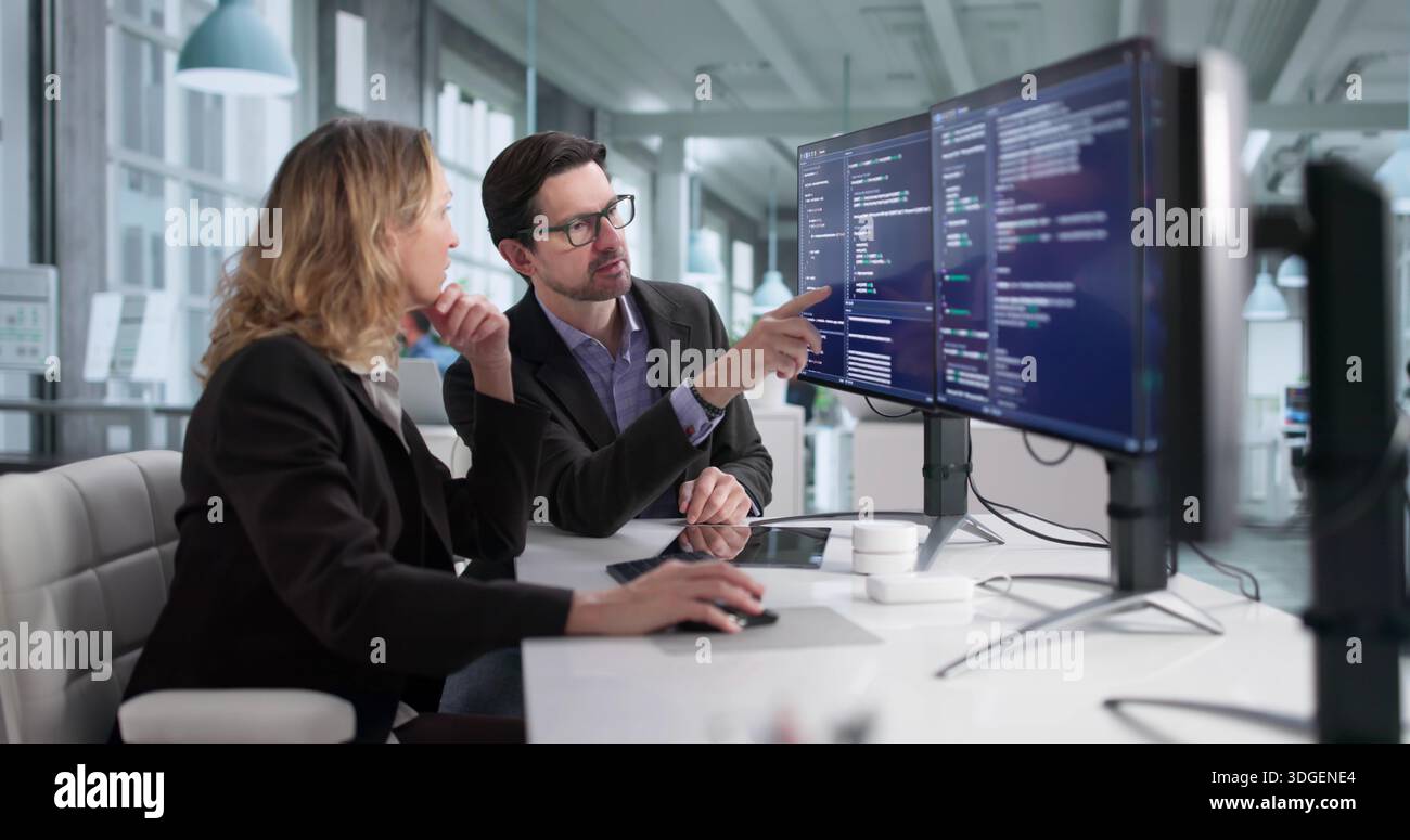 Male And Female Programmers Developing Cybersecurity Software In Office Stock Photo