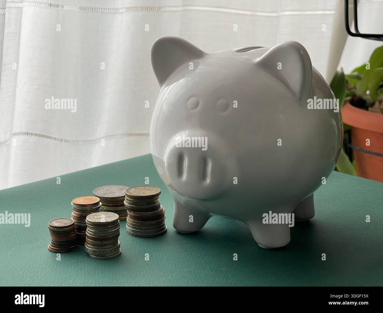 White piggy bank with coins , concept of saving, investment and financial planning. - Smartphone Captured Stock Image