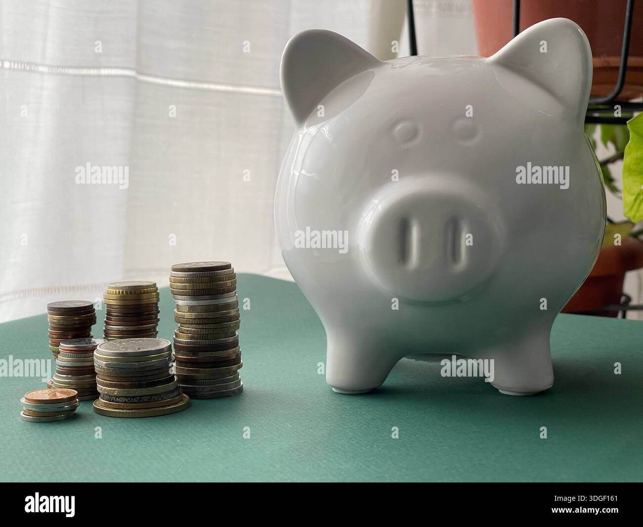 White piggy bank with coins , concept of saving, investment and financial planning. - Smartphone Captured Stock Image