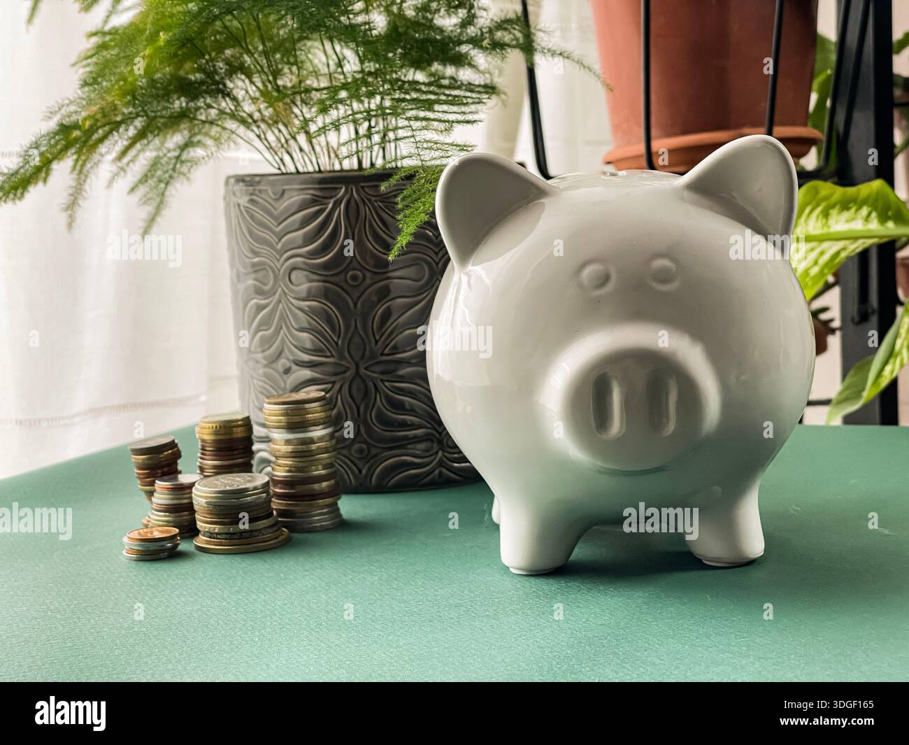 White piggy bank with coins , concept of saving, investment and financial planning. - Smartphone Captured Stock Image