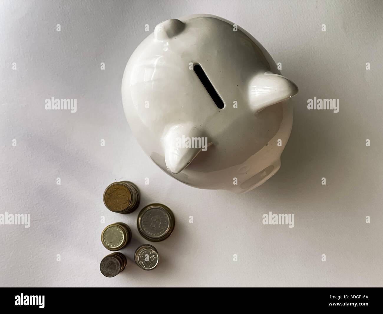 White piggy bank with coins , concept of saving, investment and financial planning. - Smartphone Captured Stock Image
