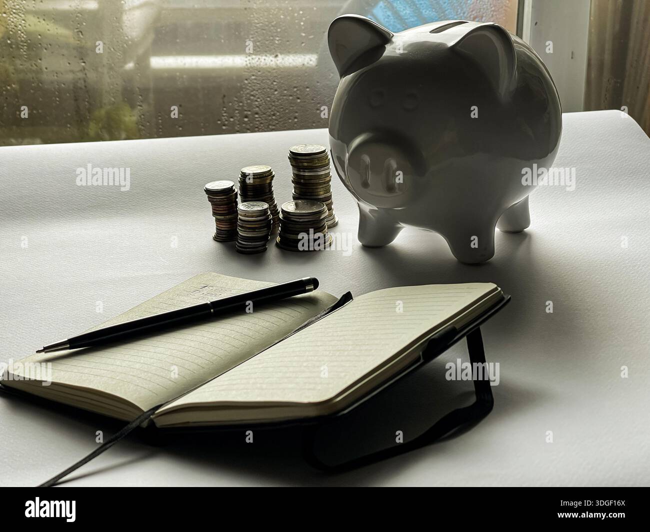 White piggy bank with coins , concept of saving, investment and financial planning. - Smartphone Captured Stock Image