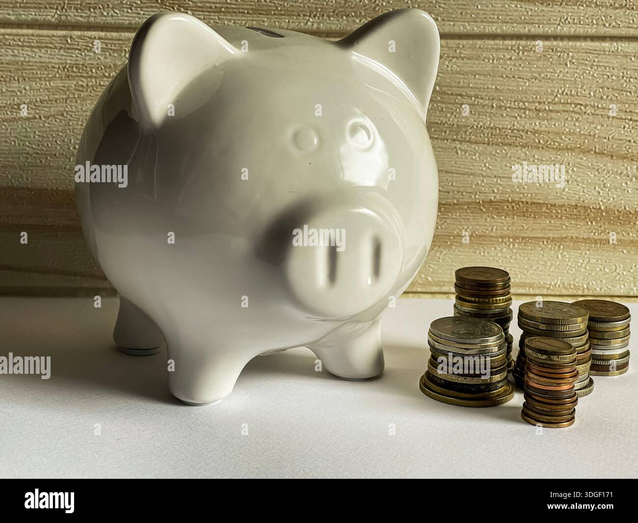 White piggy bank with coins , concept of saving, investment and financial planning. - Smartphone Captured Stock Image