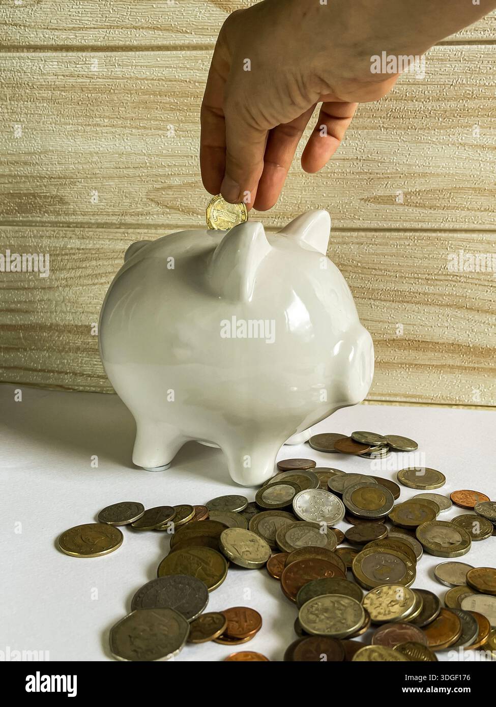White piggy bank with coins , concept of saving, investment and financial planning. - Smartphone Captured Stock Image