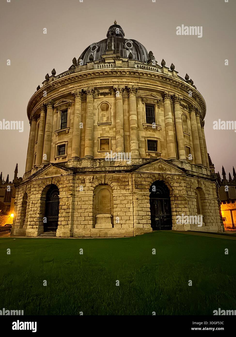 Radcliffe Camera in Oxford, England, illuminated at dusk, showcasing classical architecture and historic university heritage - Smartphone Captured Stock Image