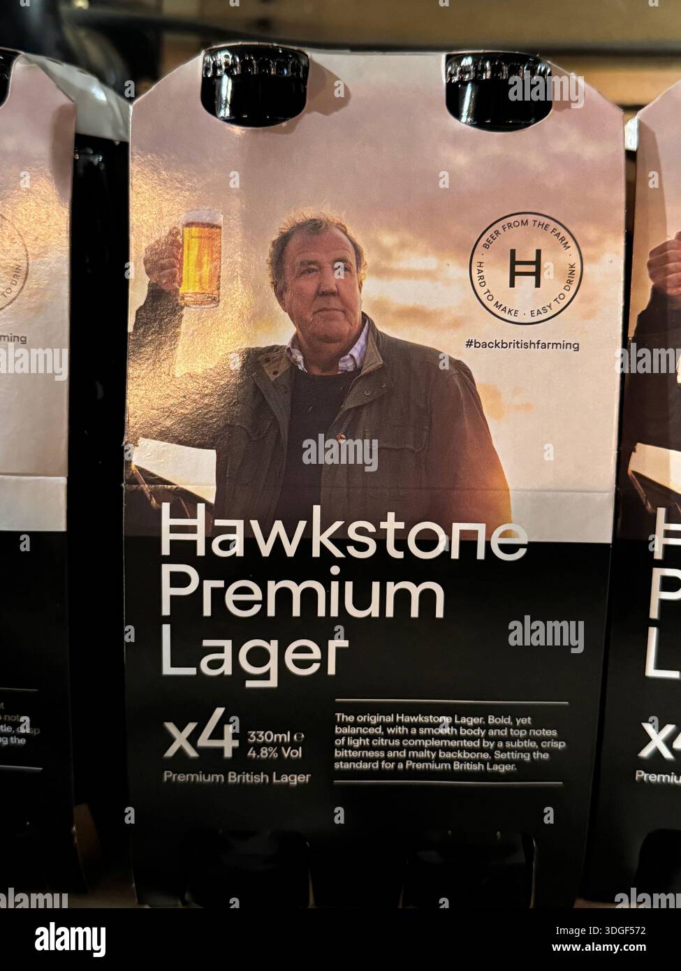Hawkstone Premium Lager multipack featuring Jeremy Clarkson on the packaging, displayed for sale in a British retail setting. - Smartphone Captured Stock Image