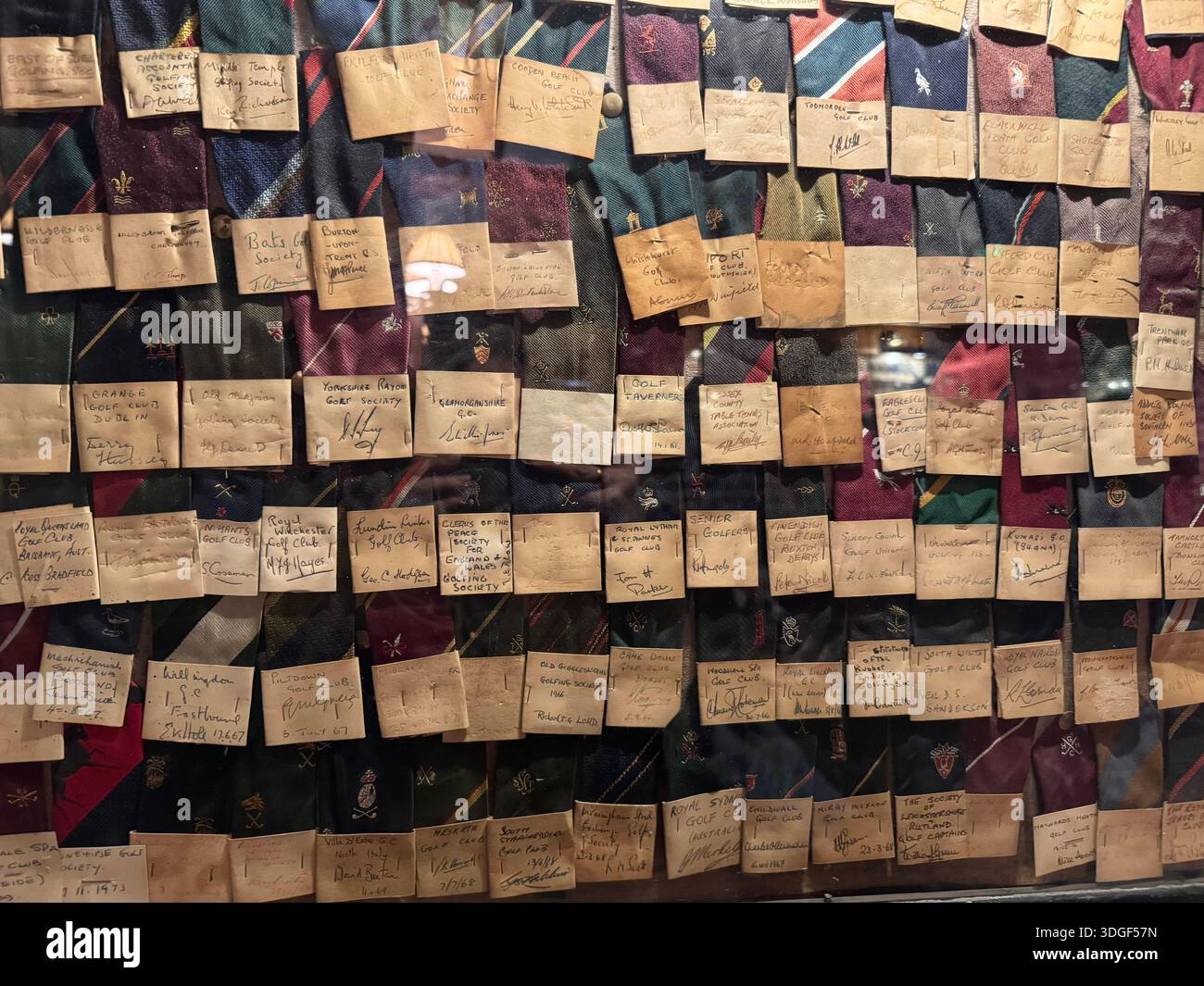 Collection of handwritten notes and signatures displayed behind glass on ties from Oxford gratuates - Smartphone Captured Stock Image