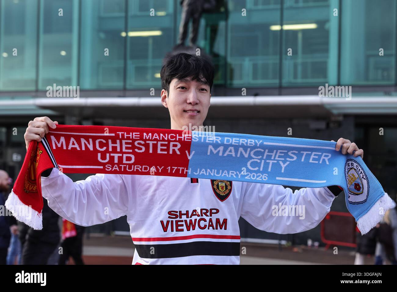 Manchester city fan holds up scarf in the hi-res stock photography