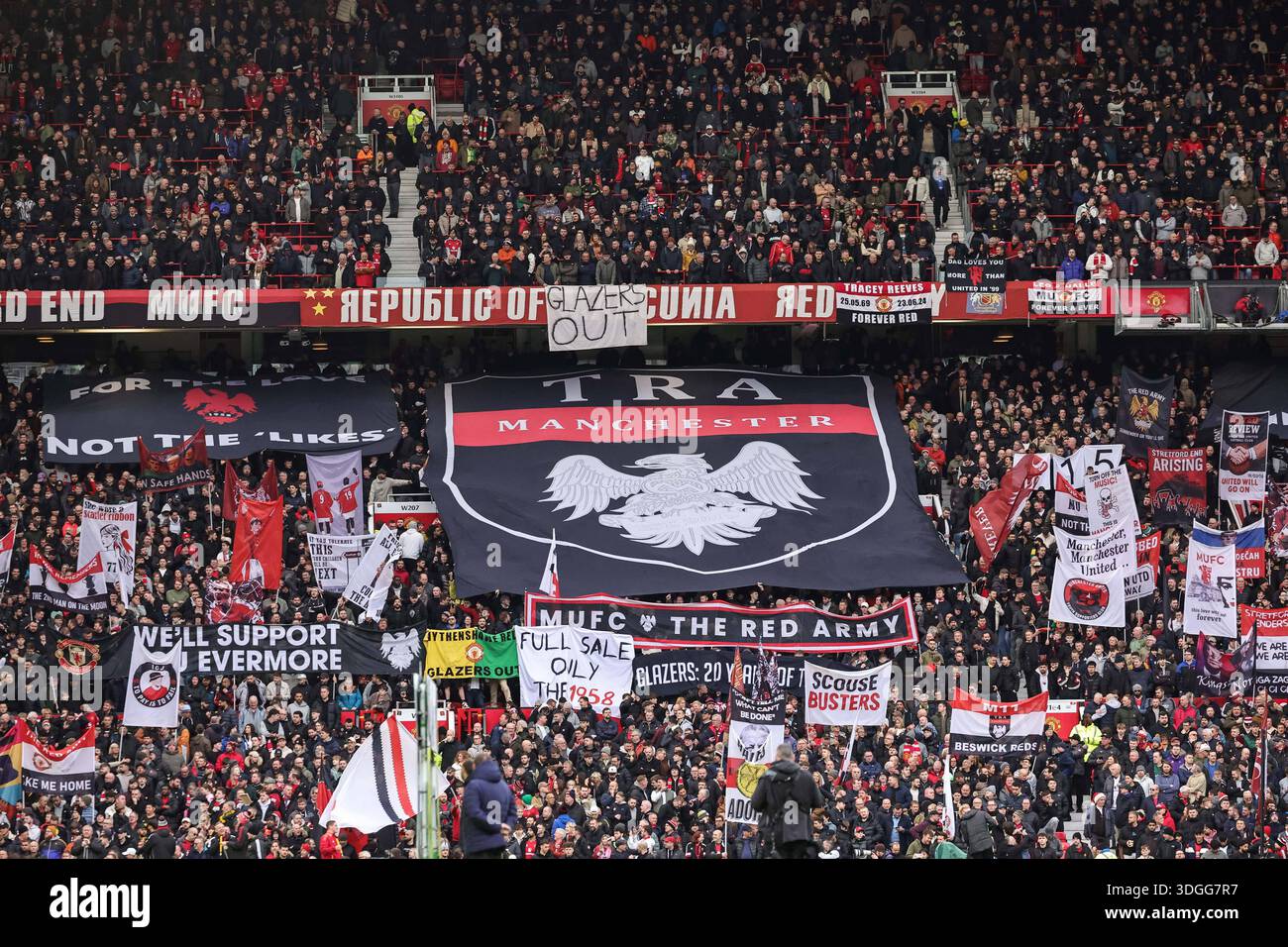 United fans hold up banners in the Stretford End during the Premier ...