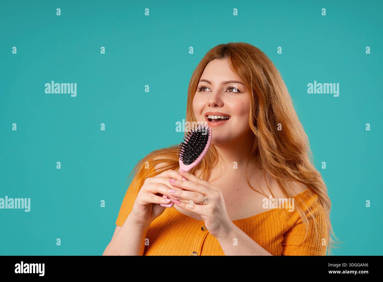 Body Positive Woman Singing, Dancing With Hair Brush Instead Microphone On Blue Stock Photo