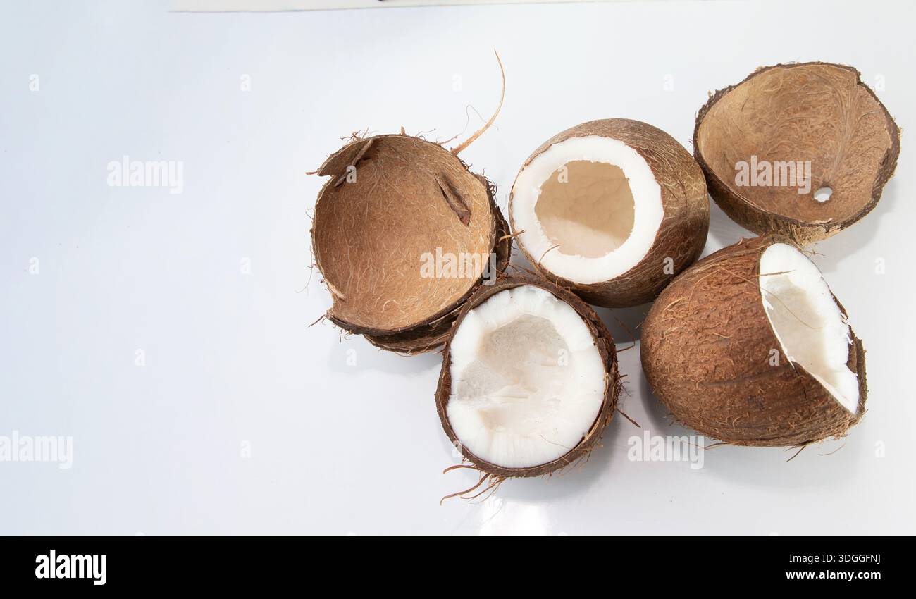 Coconut halves and empty shells on white background with copy space for design Stock Photo