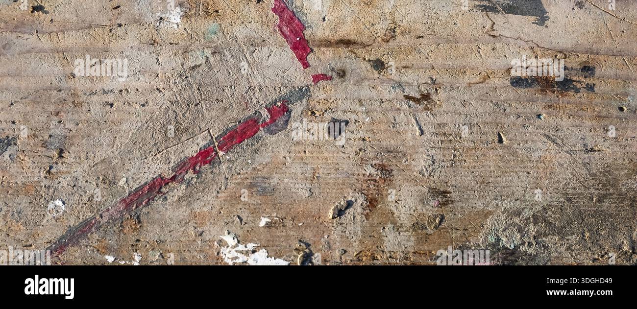 Rough concrete plastering over old wooden planks with red paint spots creating an abstract background Stock Photo