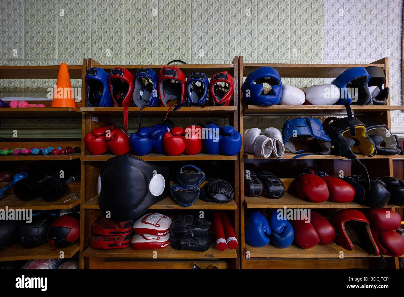 Boxing Storage Unit A storage shelf filled with boxing and martial arts equipment in a ...