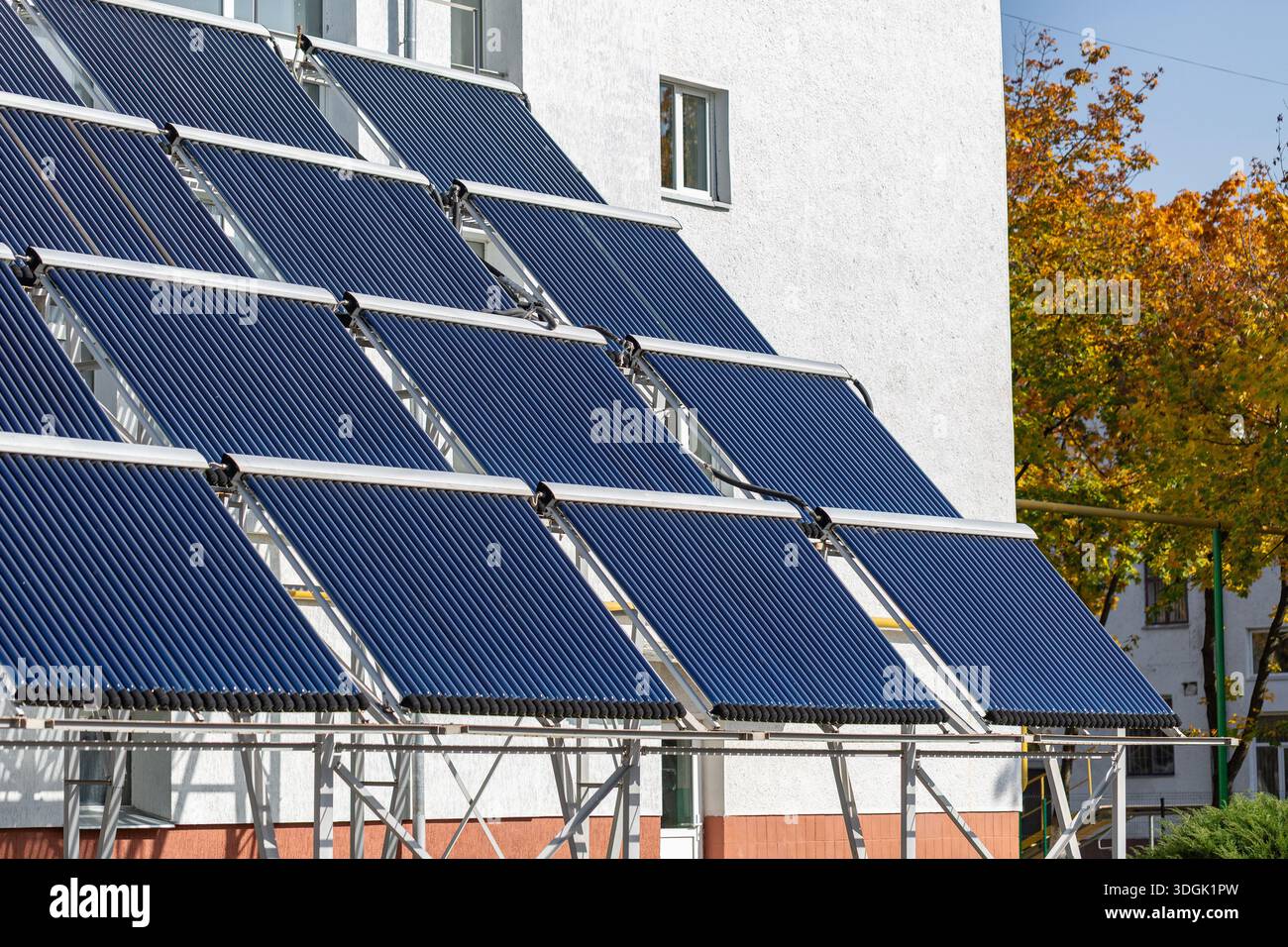 A large installation of evacuated tube solar water heaters mounted on a ...