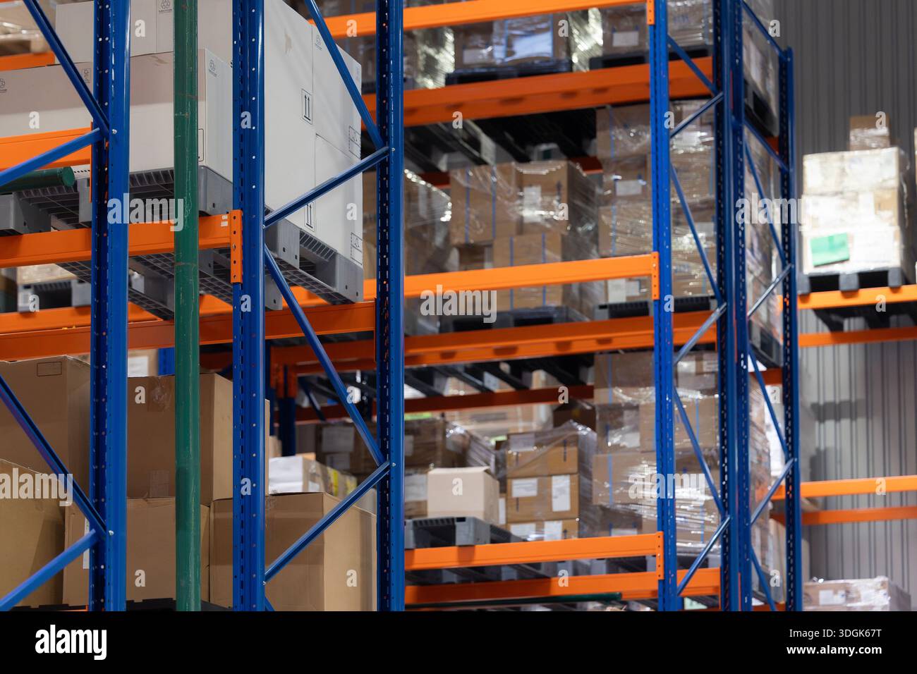 Decorating Warehouse Racking A modern warehouse interior with tall, blue and orange industrial ...
