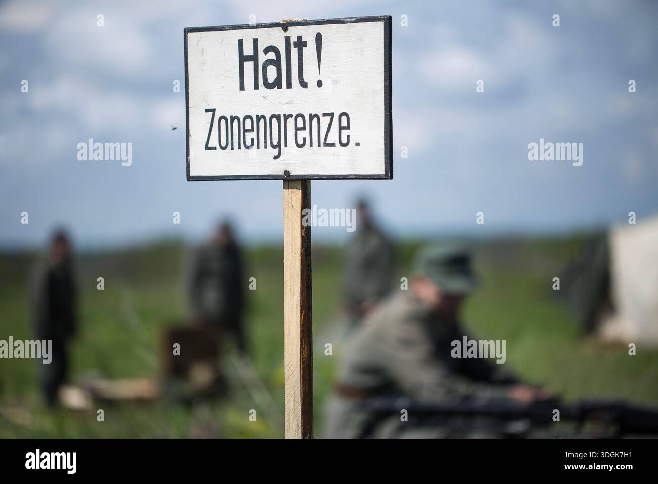 White wooden sign with German text Halt Zonengrenze meaning Zone Border ...