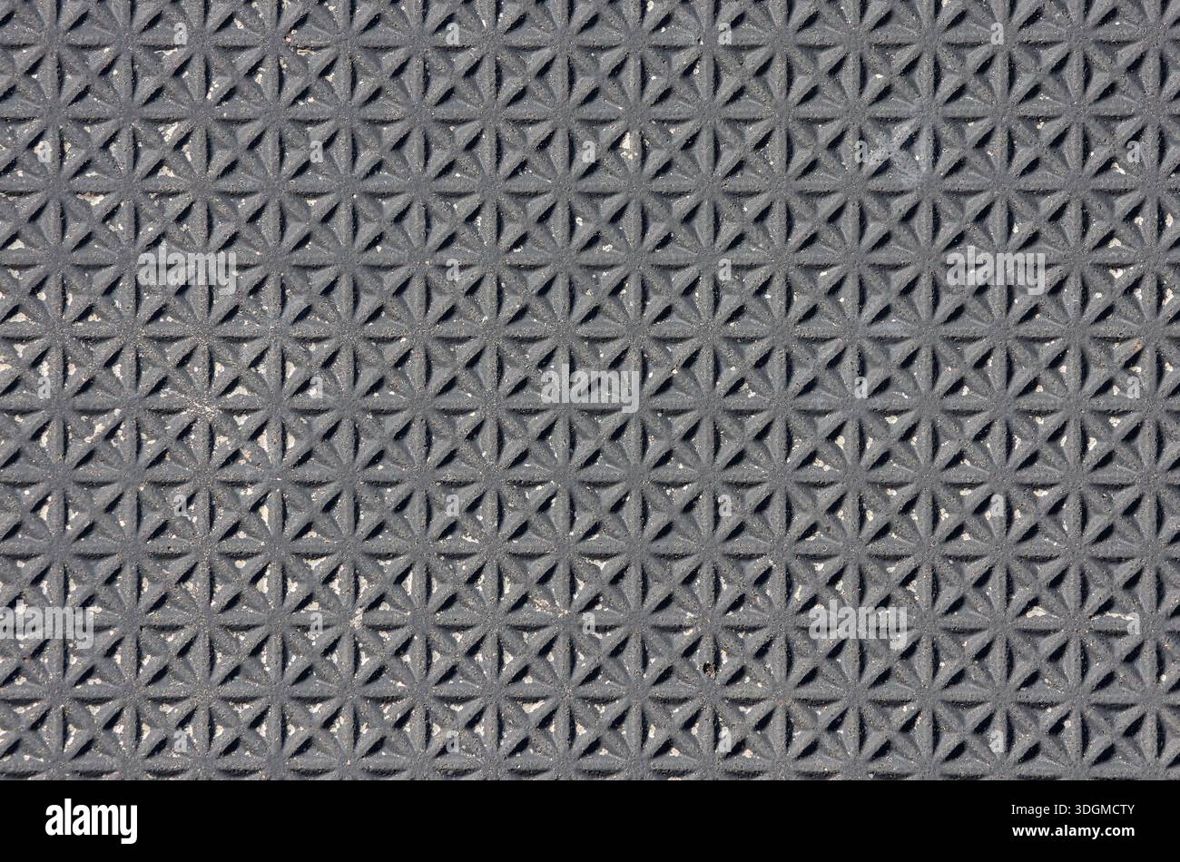 Textured surface with a repeating geometric pattern abstract background Stock Photo