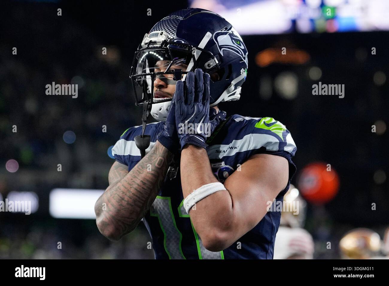 Seattle Seahawks wide receiver Jaxon Smith-Njigba (11) reacts after running  back Kenneth Walker III, not pictured, scored a touchdown during the second  half of an NFL football divisional playoff game against the